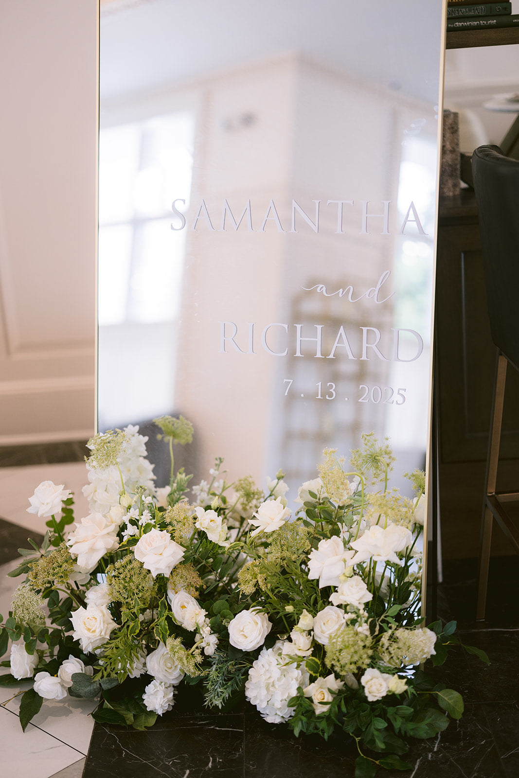 Floral arrangement in front of a mirror with engraved names and date