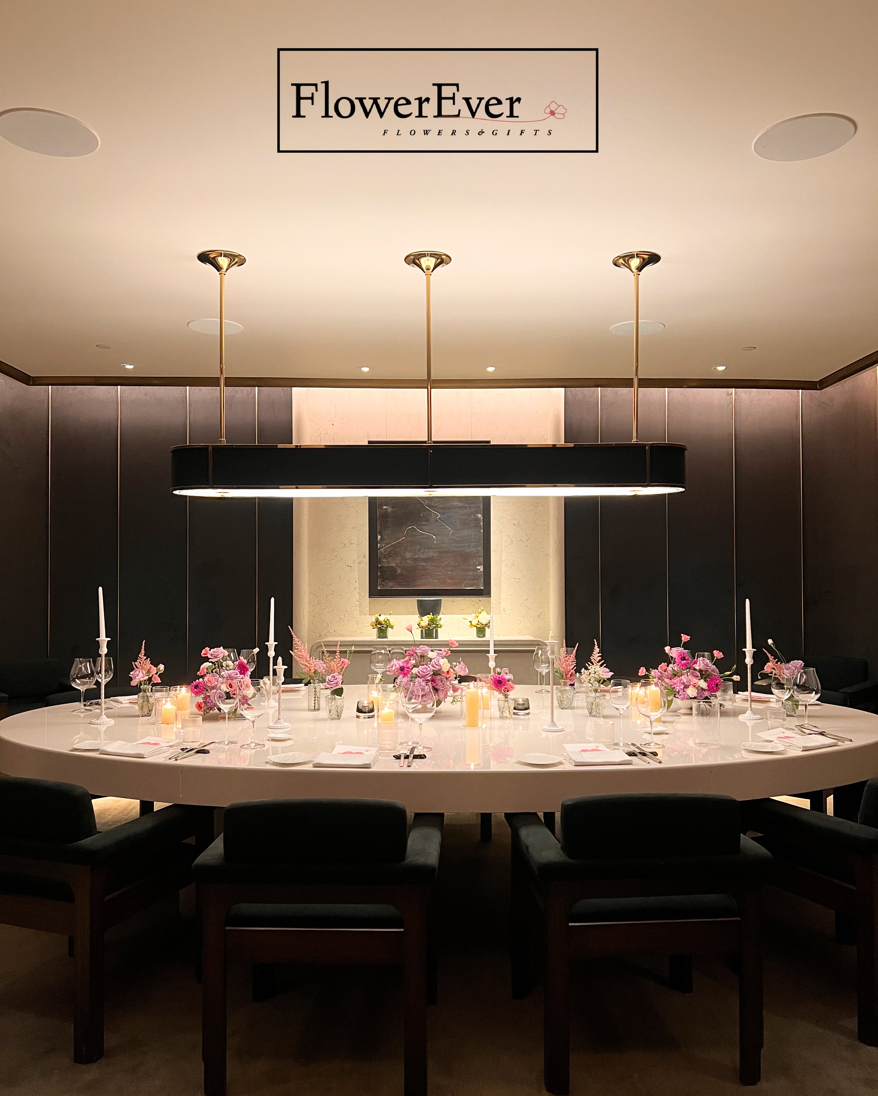 Dining room with a long table set for a meal, featuring &