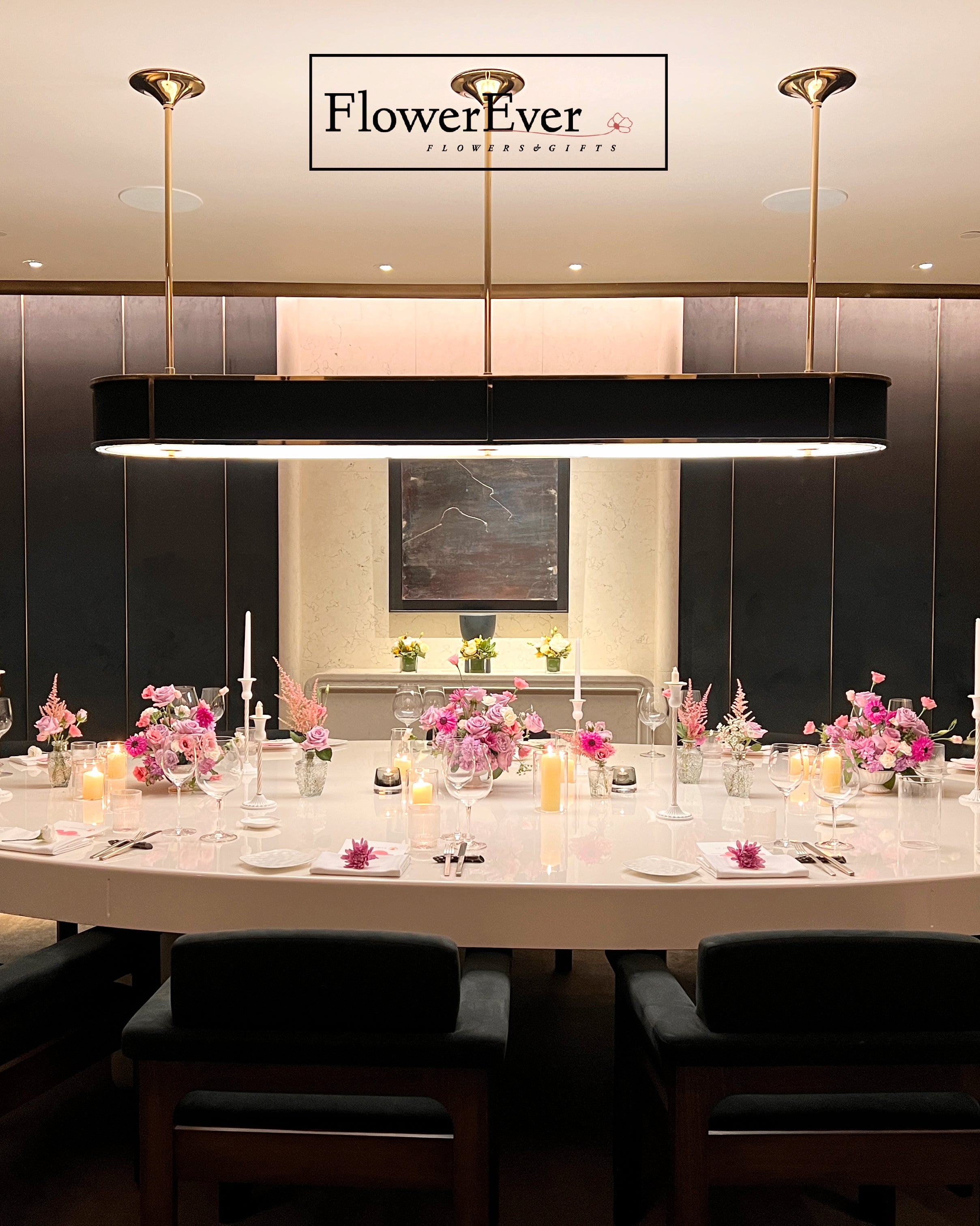 Dining table set with floral arrangements in a restaurant, featuring &