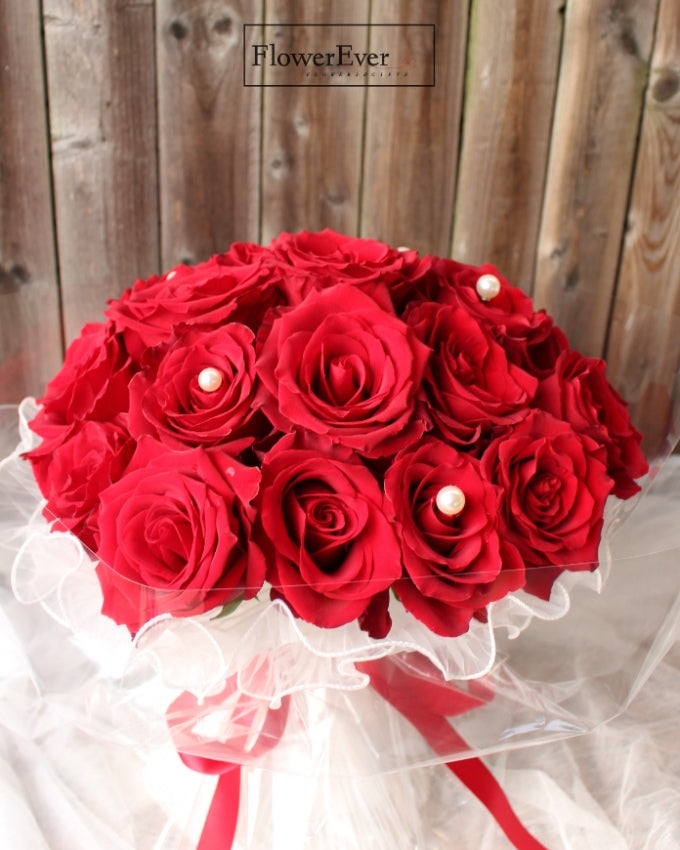 A Breathtaking Display of 24 Red Roses in White Lace & Pearl Wrapping
