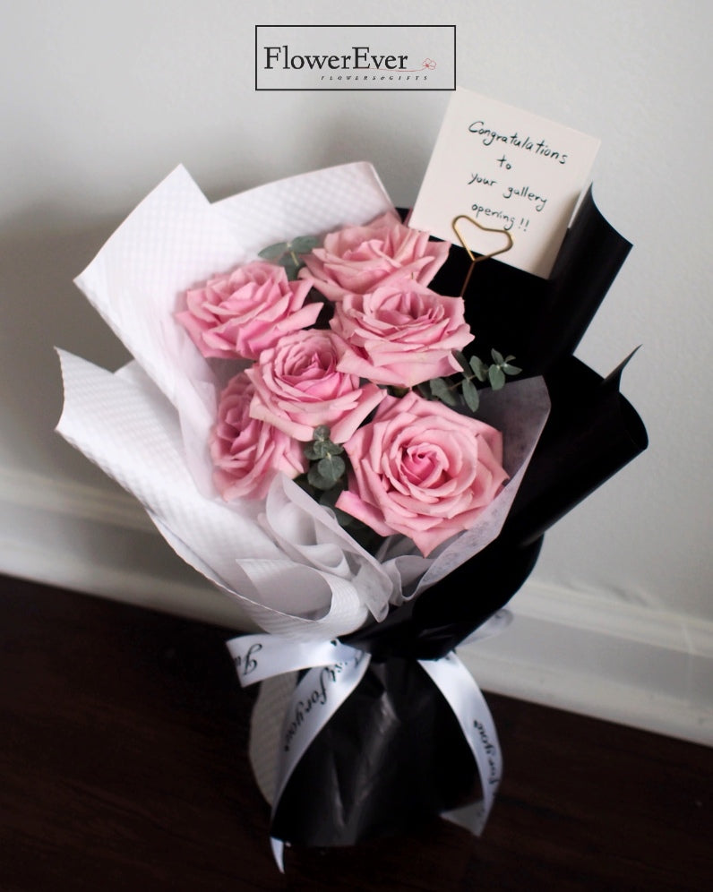 Graceful Pink Roses in a Contemporary Black & White Paper Bundle | Dozen