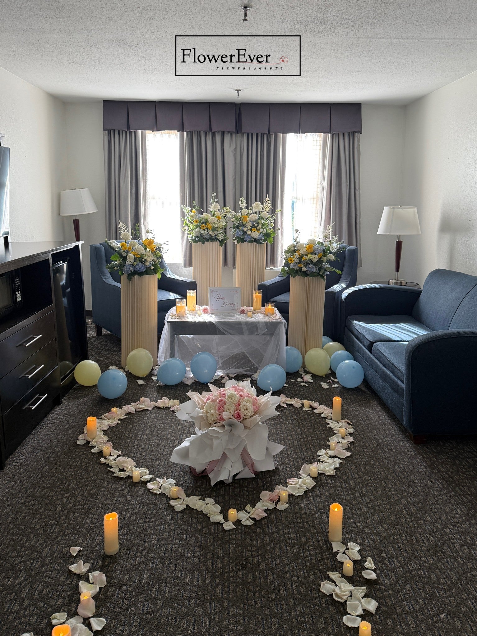 Decorative setup with flowers and candles in a living room, featuring the &