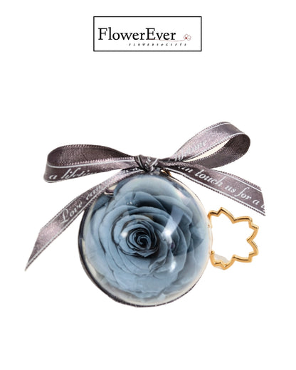 Preserved real blue rose keychain accessory.