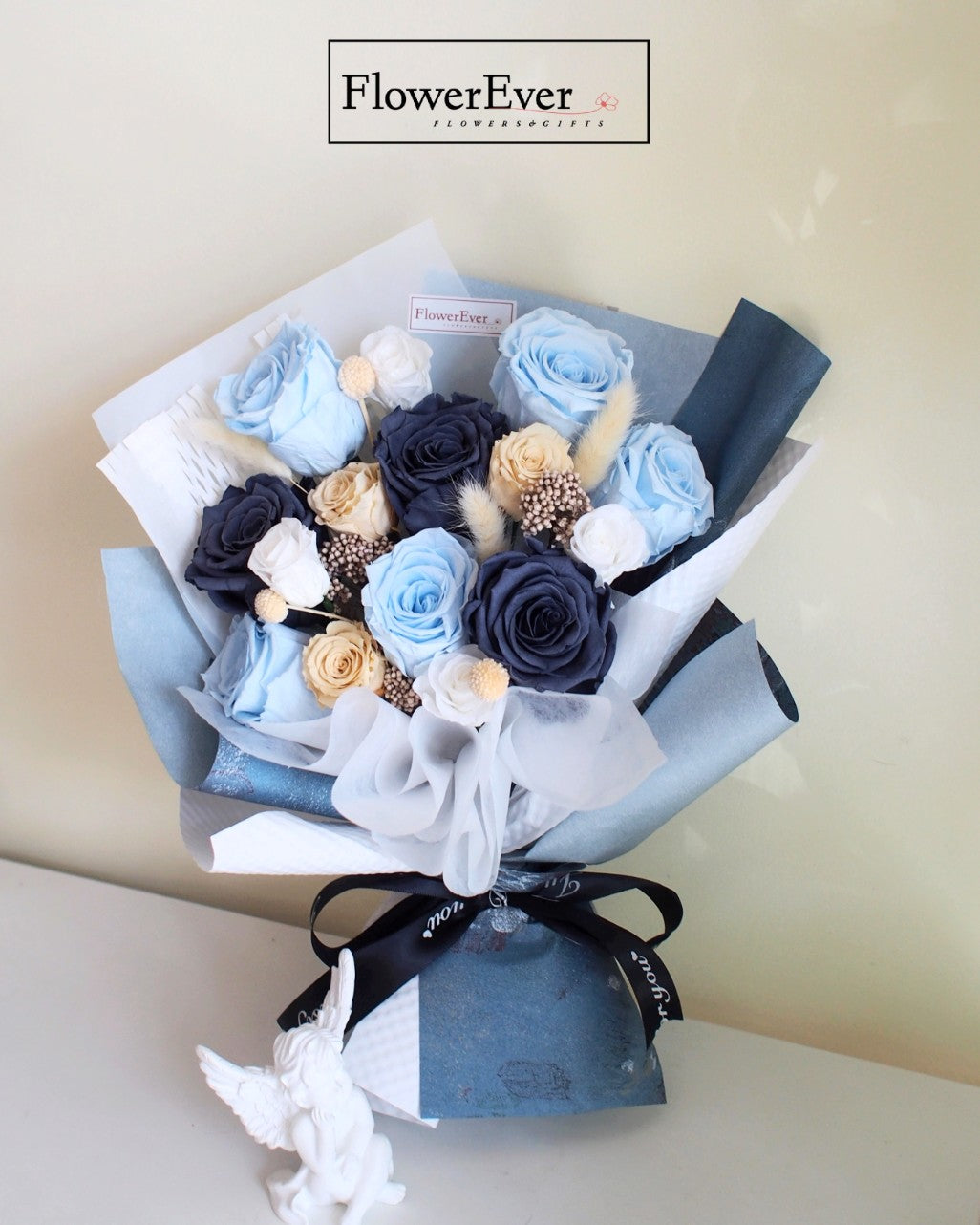 12 stems including blue preserved rose blooms mixed with nude and white flowers in a hand-tied mixed bouquet.