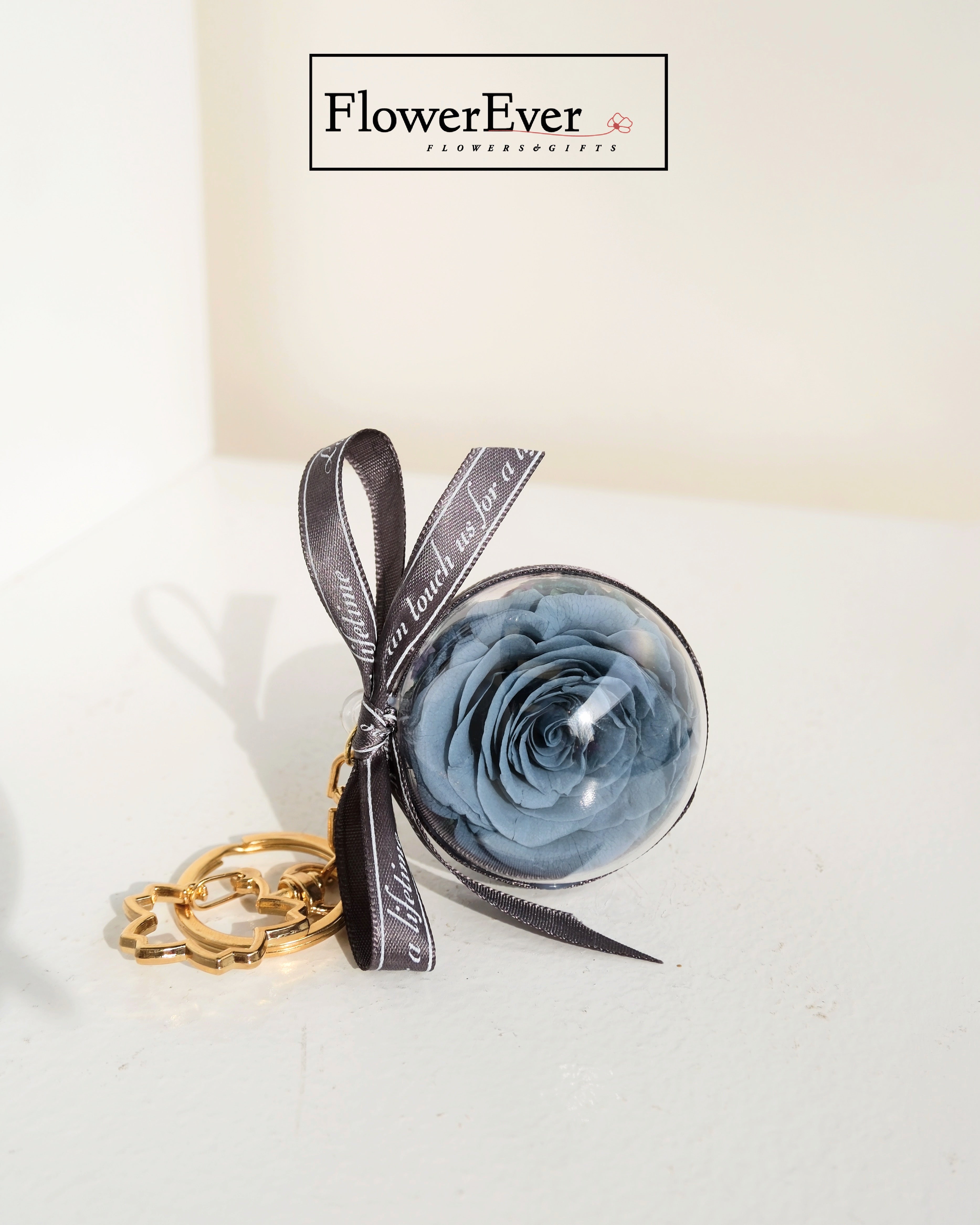 Stylish floral keyring with a real blue rose