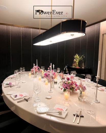 Elegant dining table setup with floral arrangements and &