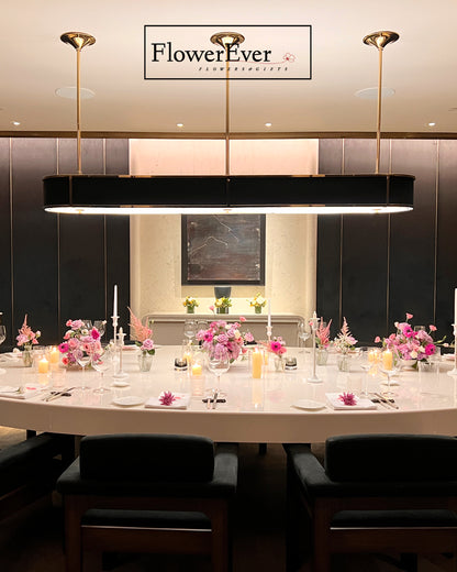 Dining table set with floral arrangements in a restaurant, featuring &