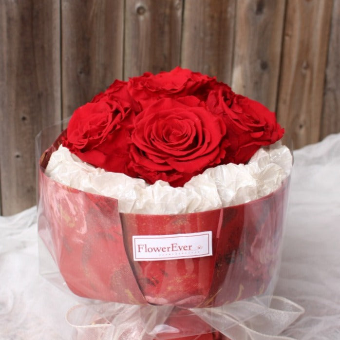 A petite Russian-style preserved flower arrangement featuring 6 stems of vivid red roses