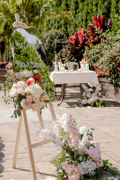 Decorative setup with floral arrangements and a &