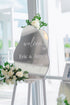 Wedding welcome sign with floral decorations in a bright room