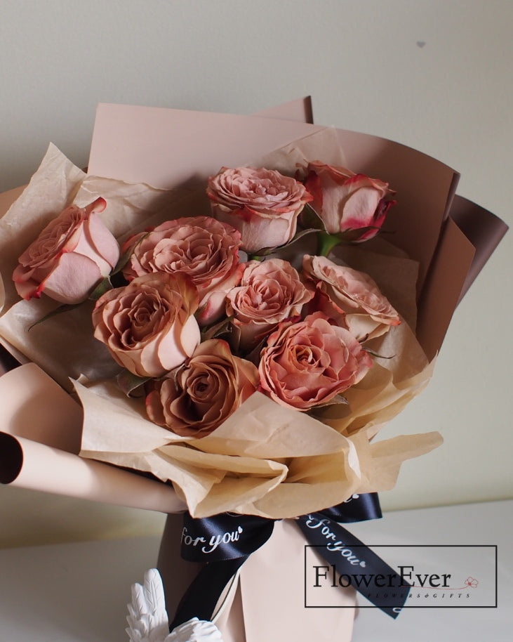 Twelve stems including preserved ivory bloom roses, latte rose buds and chocolate roses in coco shaping create this round, artfully crafted cappuccino-toned floral bouquet.