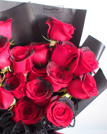 16 Stems of Midnight Red Roses in a Chic Black Paper Bouquet