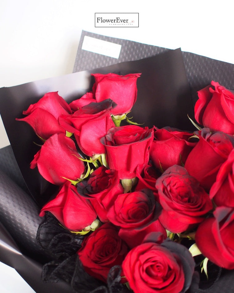 Evoke Passion with a Bouquet of 16 Midnight Red Roses in Black Paper