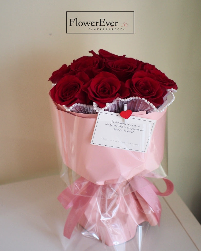 12 Fresh Red Rose Stems Presented in a Pink Floral Bucket