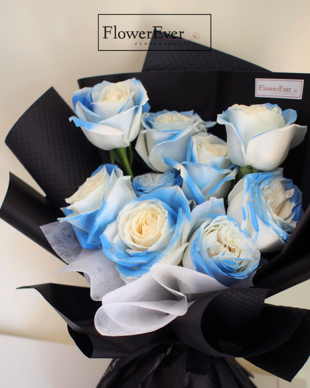 Captivating Ice Blue Roses: 12 Stems in Black Paper