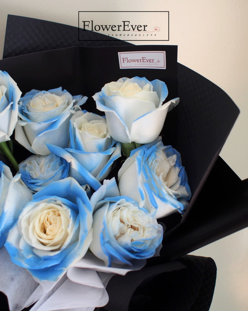 Serenade with Ice Blue: 12-Stem Rose Bouquet in Black Paper