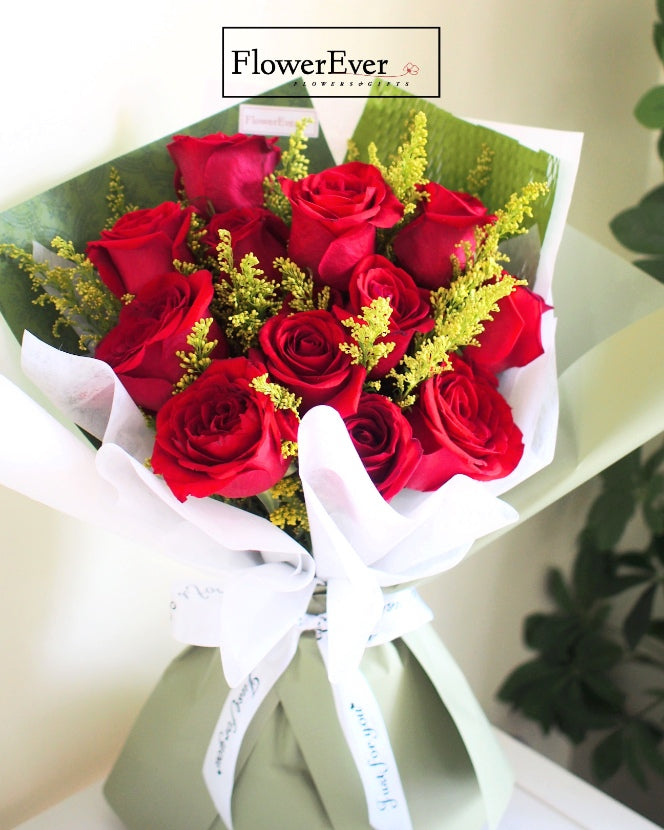 A Regal Display: 12 Crimson Red Roses Wrapped in Classy Green Paper