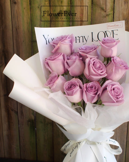 A Beautiful Bouquet of 12 Purple Roses in Lovely White Floral Paper