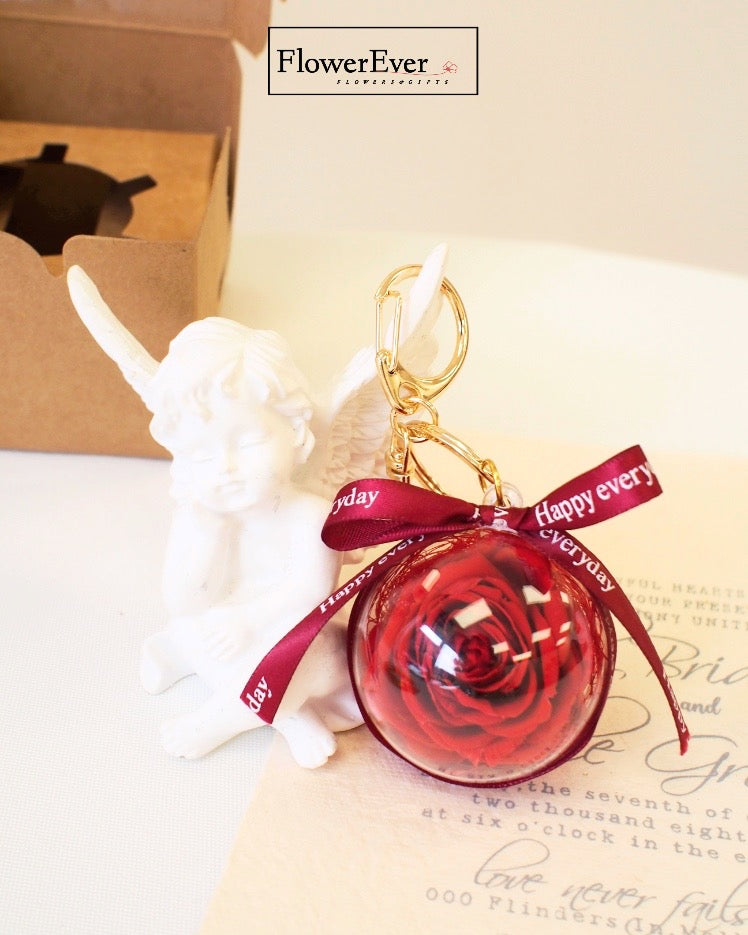 A petite preserved red rose floral charm