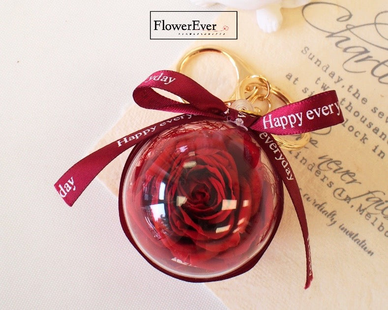 A red preserved rose floral charm