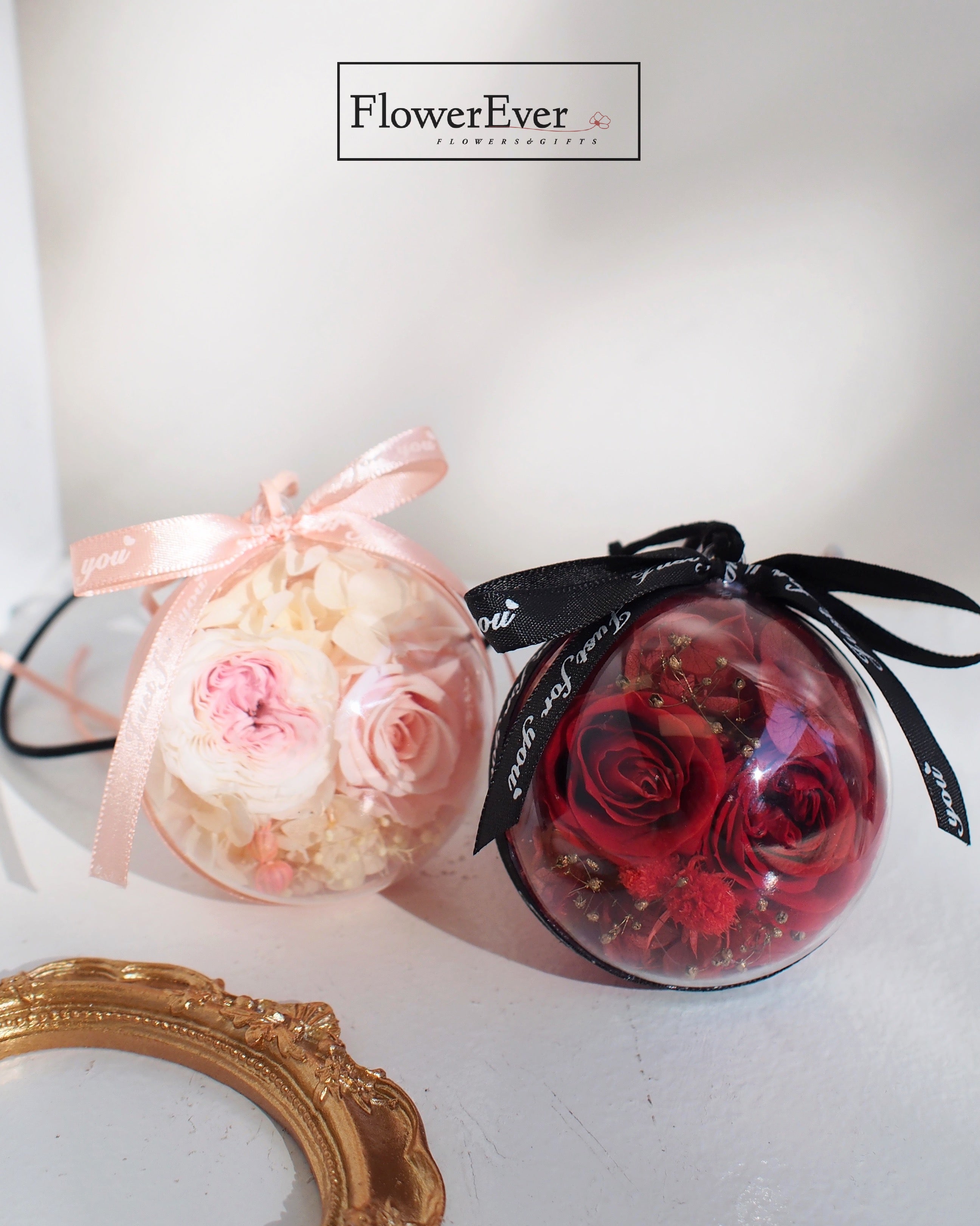 Rearview mirror decorations featuring forever roses in pink and red arrangements  