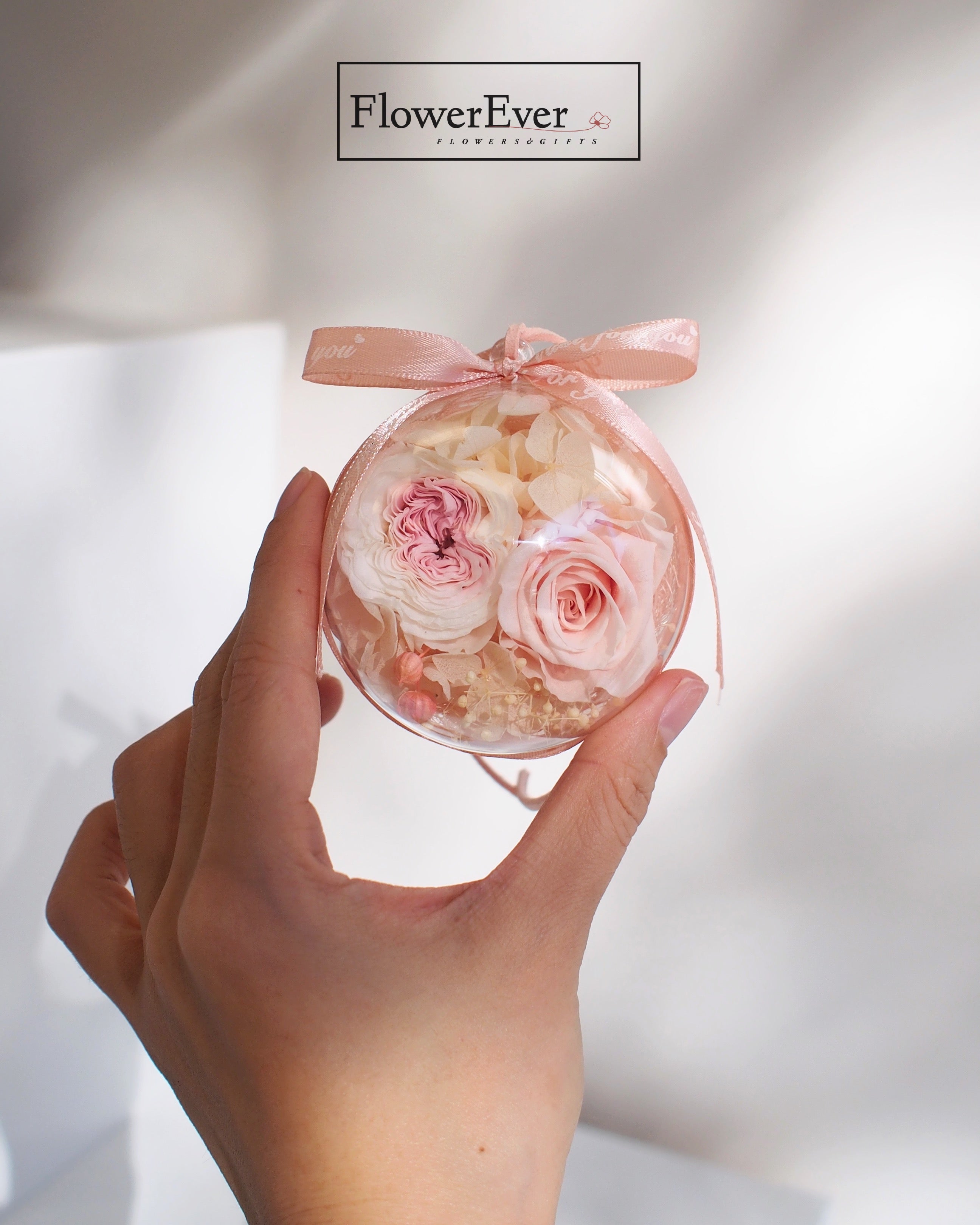 Cute pink roses hydrangea preserved and arranged inside ornament