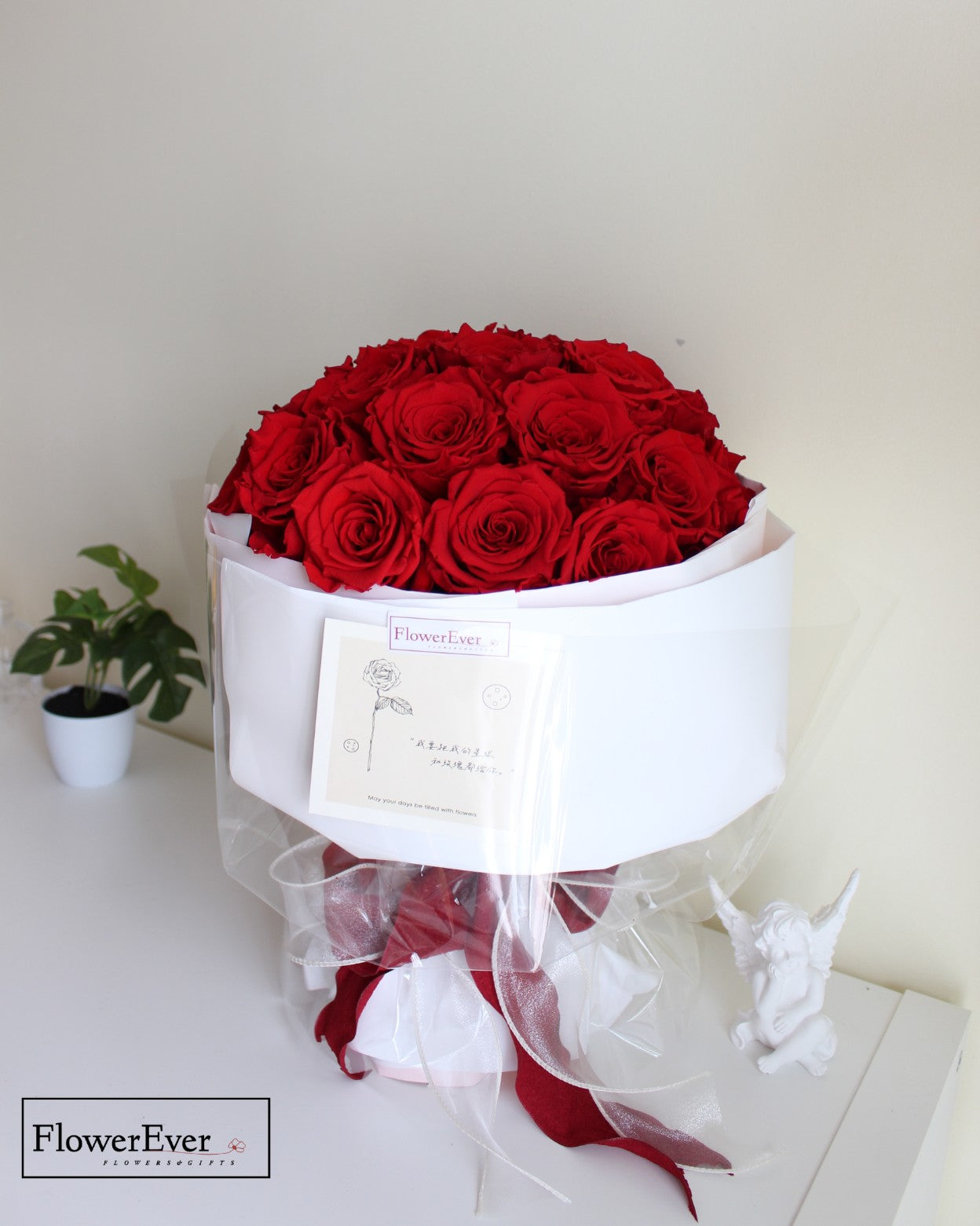 33 preserved red rose stems in a round Russian floral style bouquet wrapped in crisp white gift paper.