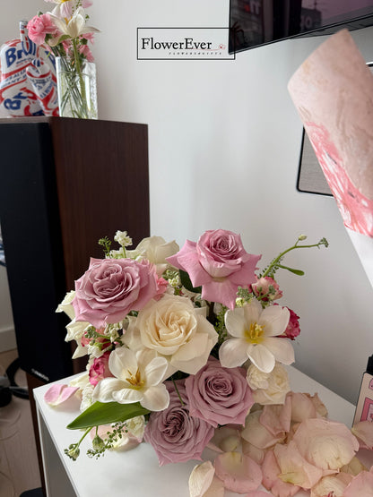 Bouquet of pink and white flowers on a table with &