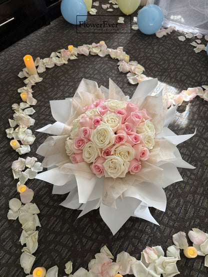 Bouquet of pink and white flowers on a dark surface with decorative elements