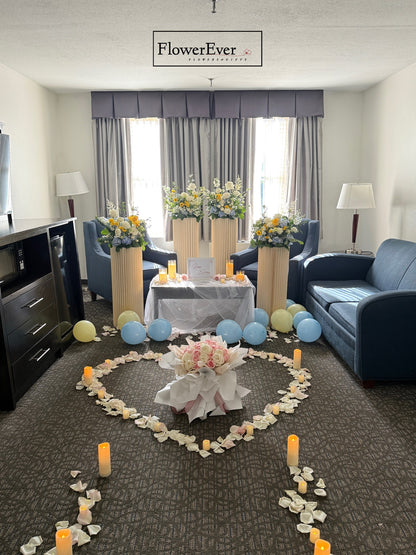 Decorative setup with flowers, candles, and balloons in a living room.