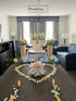 Decorative setup with flowers, candles, and balloons in a living room.